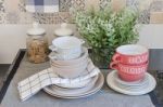 Set Of Plates And Dish On Counter In Kitchen Room Stock Photo