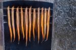 Many Hanging Eels Are Being Smoked Stock Photo