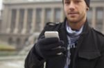 Man With Mobile Phone In Hands Stock Photo