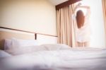 Healthy Woman Stretching In Bed Room And Open The Curtains After Stock Photo