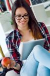 Beautiful Young Woman Using Her Digital Tablet At Home Stock Photo