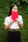 Thai Adult Student University Beautiful Girl Reading Red Book Stock Photo