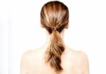 Back View Of Beautiful Woman Looks Ahead Stock Photo