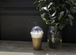 Iced Milk Coffee On Sunshine Wooden Table Stock Photo