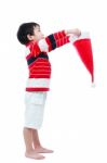 Asian Boy Hold Santa Hat Looking Upwards Stock Photo