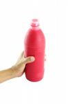 Red Water Bottle In Hand On White Background Stock Photo