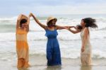 Portrait Of Young Asian Woman With Happiness Emotion Wearing Beautiful Dress Dancing On Sea Beach And Laughing Joyful Use For People Relaxing Vacation On Destination Stock Photo