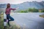 Tourist Hitchhiking Woman Standing On The Road In The Mountains Stock Photo