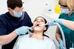 Dentist Examining A Woman Teeth Stock Photo