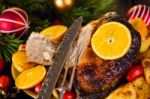 Christmas Baked Duck Served With Potatoes, Orange And Tomatoes Stock Photo