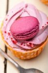 Pink Berry Cream Cupcake With Macaroon On Top Stock Photo