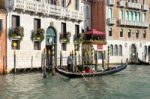 Gondolier Ferrying A Passenger Along The Grand Canal Stock Photo