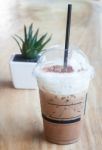 Iced Coffee With Green Plant Background Stock Photo