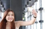 Portrait Of Thai Adult Beautiful Girl Using Her Smart Phone Selfie Stock Photo