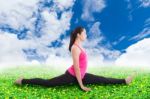 Asian Woman Practicing Yoga, Exercise Called Monkey Pose Stock Photo