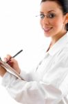 Lady Doctor Writing On Clipboard Stock Photo