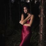 Beautiful Young Woman In The Gardens Wearing A Long Silk Red Dress Stock Photo