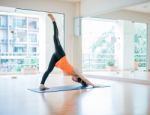 Asian Woman Doing Yoga Indoors Stock Photo