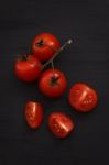 Organic Fresh Cherry Tomatoes On Black Board Background Stock Photo