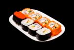 Sushi In White Plate On Black Background Stock Photo