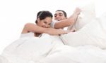 Playful Young Beautiful Couple With Pillows Stock Photo