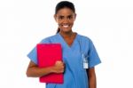 Female Nurse Holding Clipboard, At Duty Stock Photo