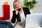 Cheerful Lady Engaged In A Jovial Conversation Stock Photo