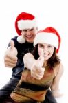 Christmas Couple Showing Thumbs Up Stock Photo