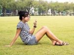 Woman Relaxing And Listening To Music Outdoors Stock Photo