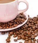 Coffee Beans Next To A Cup Of Freshly Brewed Stock Photo