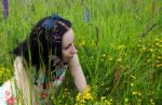 Young Woman Lying On The Grass Stock Photo