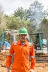 Excavator And Workers Stock Photo