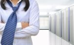 Woman Standing In Communication And Internet Network Server Room Stock Photo