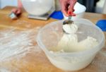 Hand Holding Spoon With Flour Stock Photo