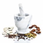 Marble Mortar And Pestle With Assorted Spices On White Backgroun Stock Photo