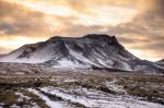 Snowy Icelandic Mountains With Dramatic Cloudy Sky Stock Photo