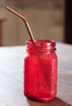 Iced Drink In Red Glass On Wooden Table Stock Photo