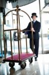 Doorman Pushing A Cart Stock Photo