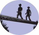 Hikers Crossing Single Log Bridge Oval Woodcut Stock Photo