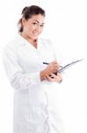 Young Female Doctor Writing On Notepad Stock Photo