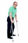 Physically Disabled Old Man With Crutches Stock Photo