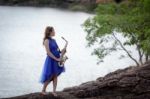 Beautiful Woman Wear Blue Evening Dress Holding Saxophone Stand Stock Photo