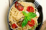 Spaghetti Pasta With Baked Cherry Tomatoes And Basil Stock Photo