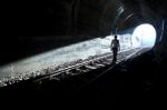 Man Standing In Train Tunnel Stock Photo