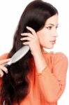 Pretty Woman Combing Hair Stock Photo