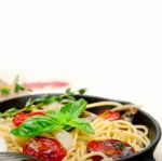 Spaghetti Pasta With Baked Cherry Tomatoes And Basil Stock Photo