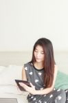 Woman Using A Tablet-pc On The Bed Stock Photo