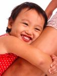 Child Hugging Her Mother's Leg Stock Photo