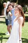 Four Teens Hang Out In A Park Stock Photo