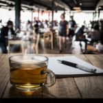 Hot Tea With Notebook And Pen On Wooden Table Stock Photo